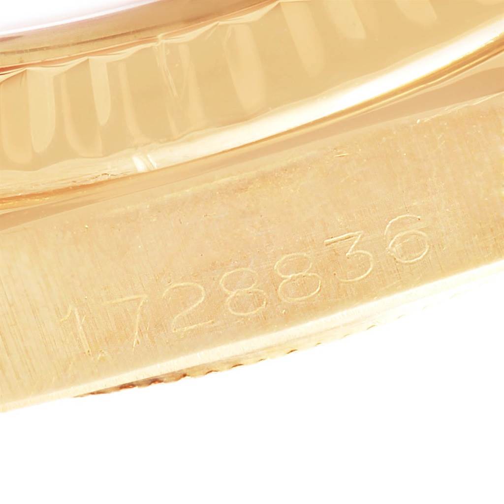 This image shows a close-up of the side of a Rolex President 1807 Men
s Yellow Gold Champagne Dial 1807 Men
s Yellow Gold Champagne Dial model watch, focusing on the serial number engraving.
