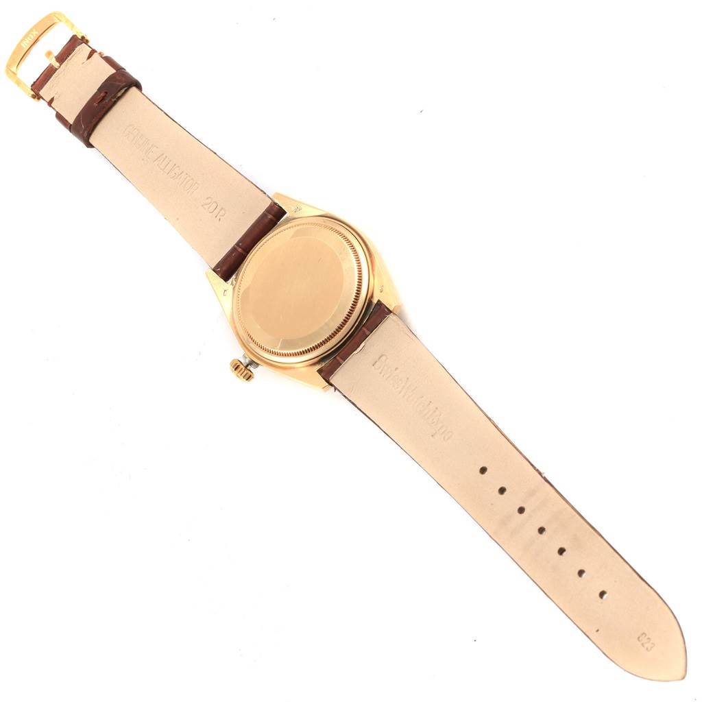 The image shows a Rolex President 18038 Men
s Yellow Gold Champagne Dial 18038 Men
s Yellow Gold Champagne Dial model watch from the back, including the case back and leather strap.