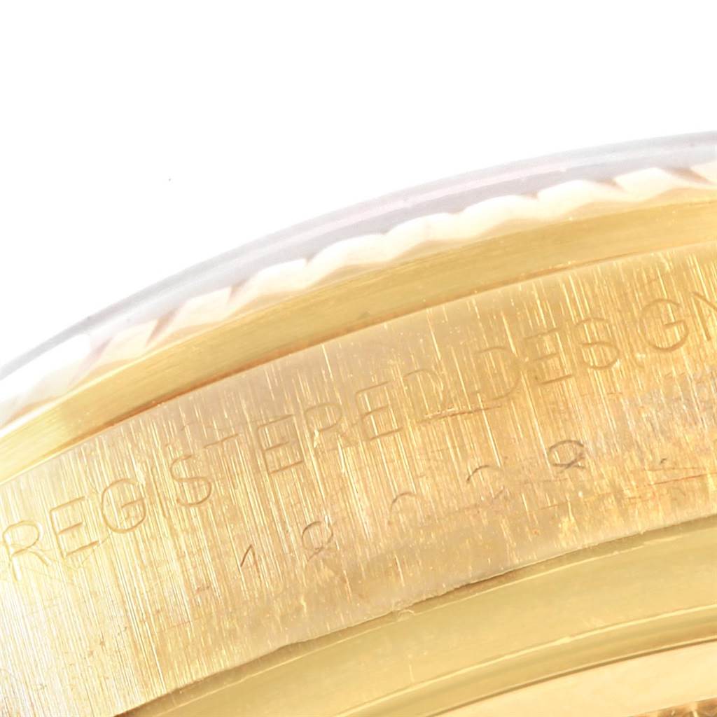 The image shows a close-up angle of the engraved gold bezel on a Rolex President 18038 Men
s Yellow Gold Champagne Dial 18038 Men
s Yellow Gold Champagne Dial model watch.