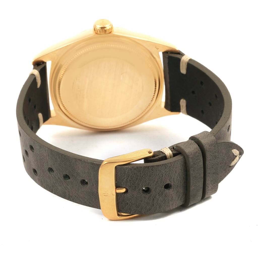 The image shows the back case and leather strap of the Rolex President 1803 Men
s Yellow Gold Champagne Dial 1803 Men
s Yellow Gold Champagne Dial model watch from a rear angle.