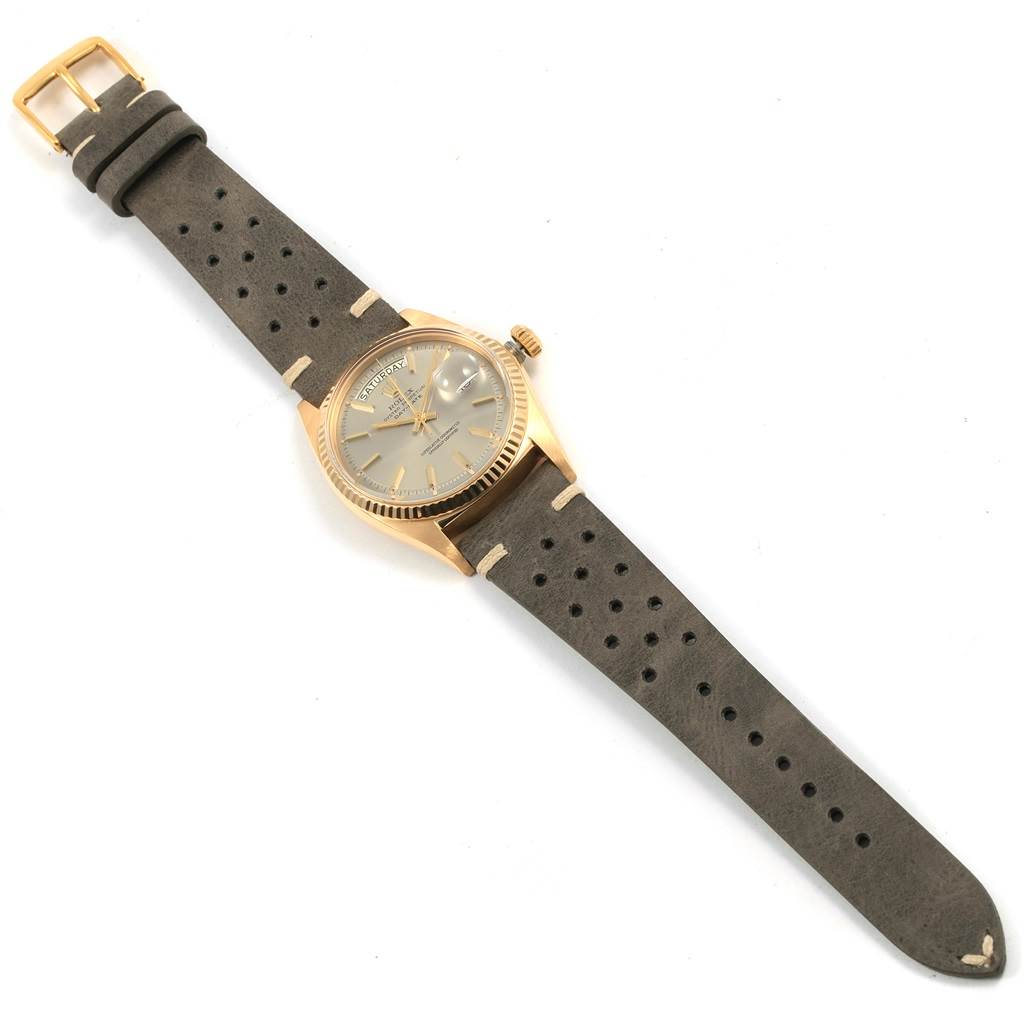 The Rolex President 1803 Men
s Yellow Gold Champagne Dial 1803 Men
s Yellow Gold Champagne Dial model watch is shown from a top-down angle, highlighting the face, case, crown, and its dark leather strap with perforations.