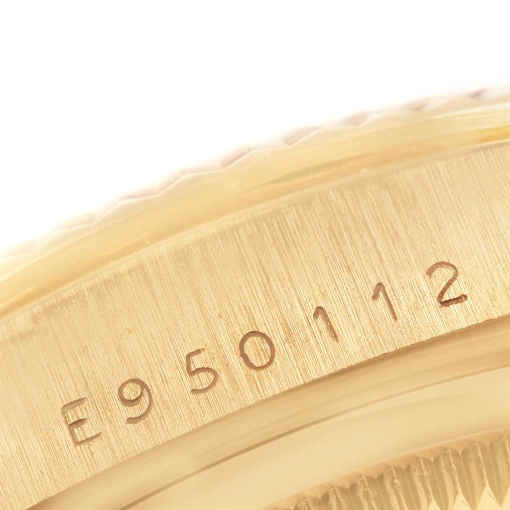 This close-up image shows the serial number engraved on the gold case of a Rolex President 18238 Men
s Yellow Gold Black Dial 18238 Men
s Yellow Gold Black Dial model watch.