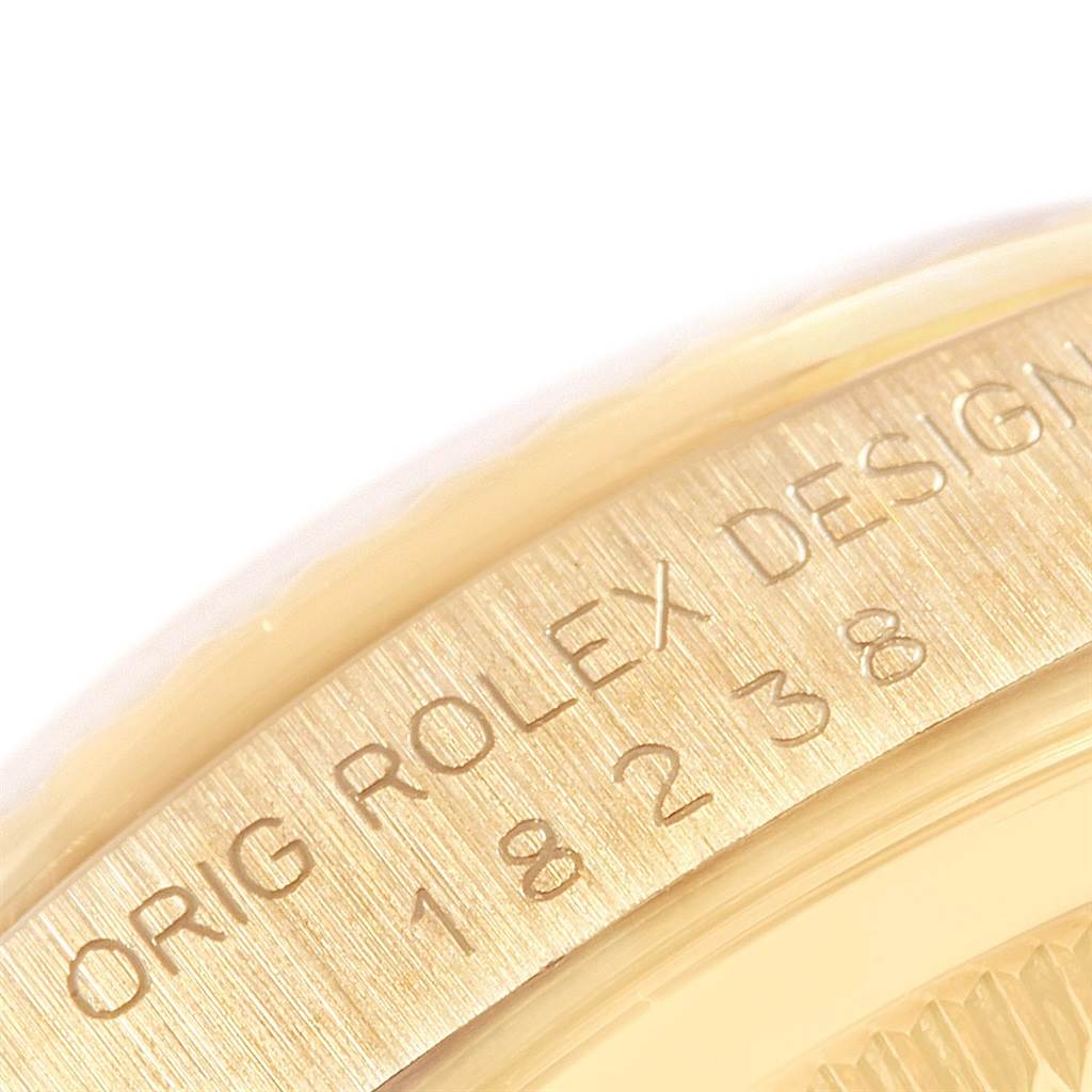 The image shows a close-up of the edge inscription on a Rolex President 18238 Men
s Yellow Gold Black Dial 18238 Men
s Yellow Gold Black Dial watch.