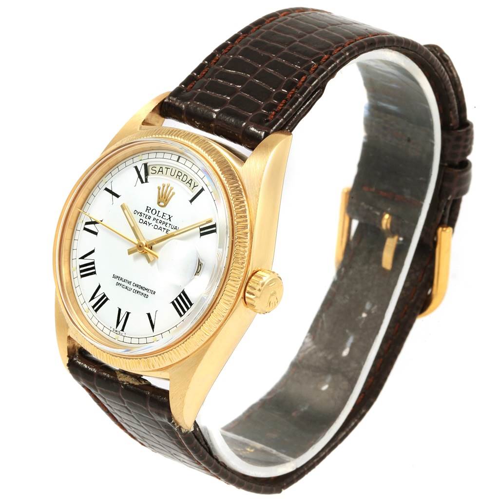 The Rolex President 1807 Men
s Yellow Gold White Dial 1807 Men
s Yellow Gold White Dial model watch is shown at an angle displaying the dial, bezel, crown, and part of the leather strap.