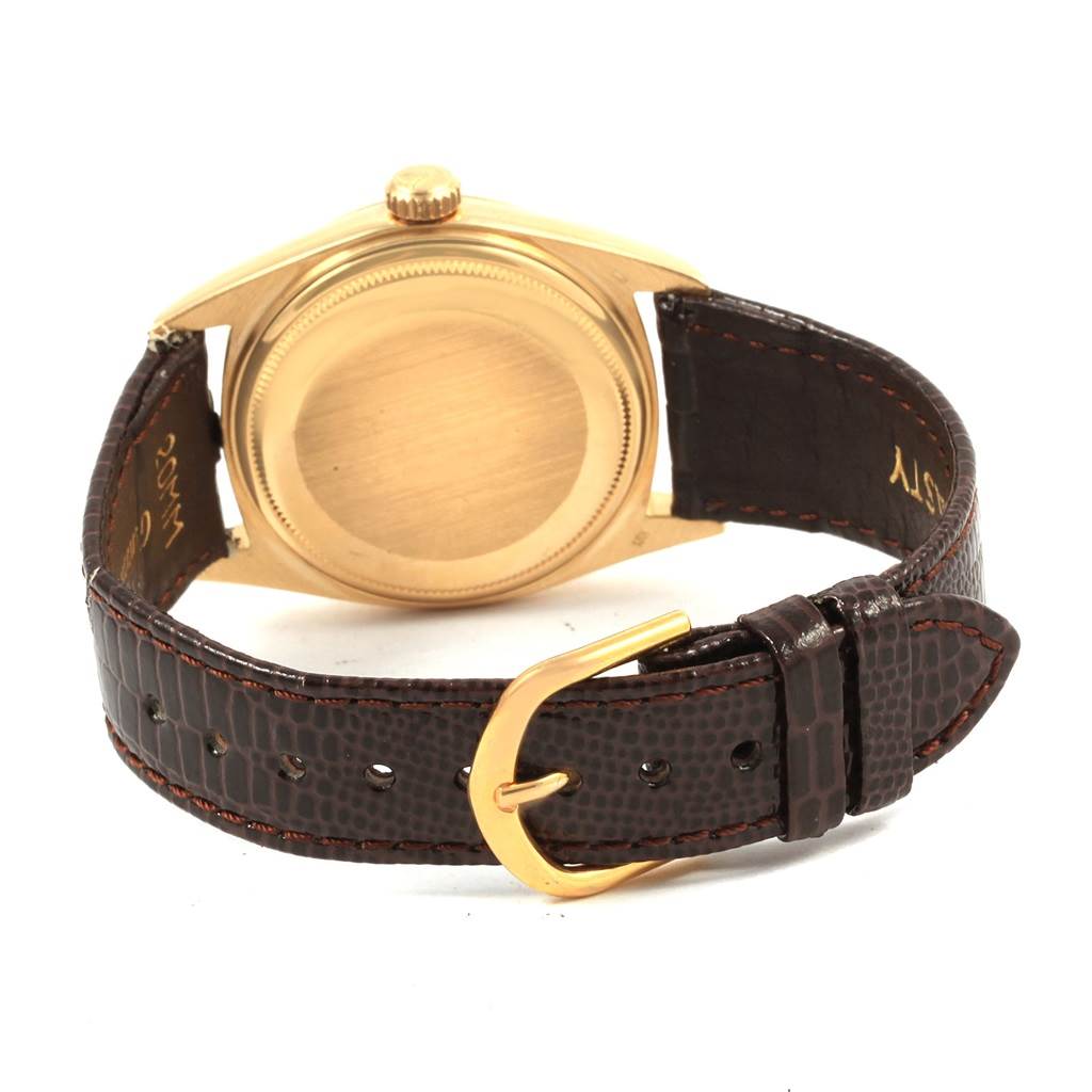 This image shows the back view of a Rolex President 1807 Men
s Yellow Gold White Dial 1807 Men
s Yellow Gold White Dial model watch with a leather strap and gold clasp.