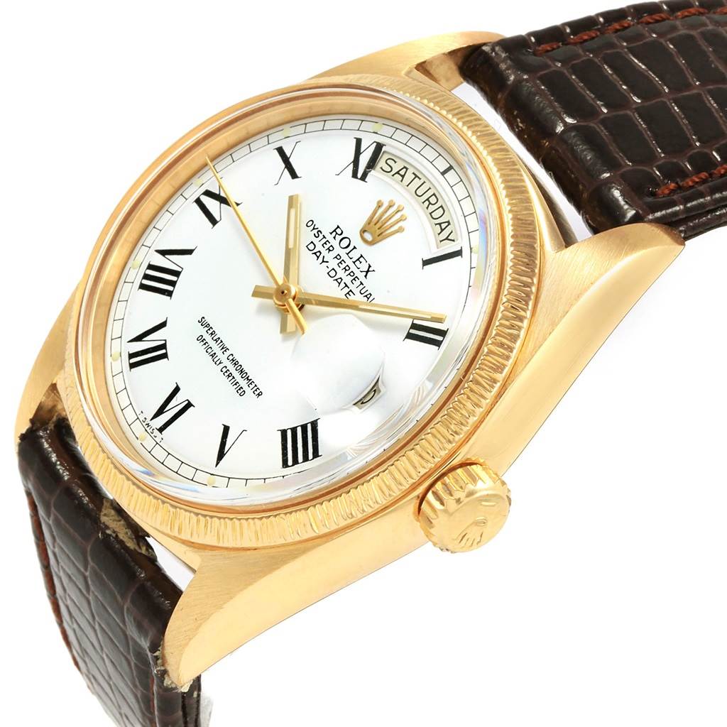 The image shows a Rolex President 1807 Men
s Yellow Gold White Dial 1807 Men
s Yellow Gold White Dial watch at an angle highlighting its face, crown, and leather strap.
