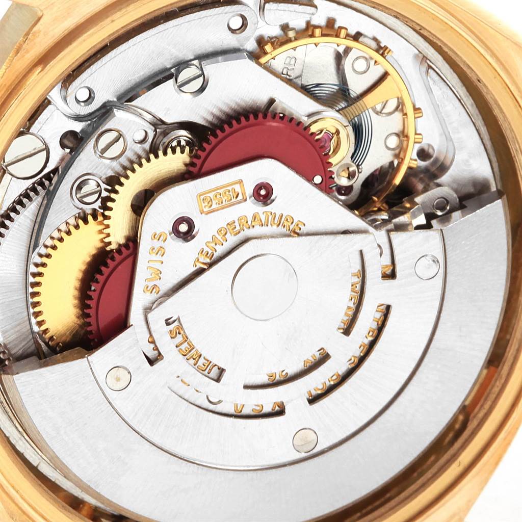 This image shows a close-up view of the movement inside a Rolex President 1807 Men
s Yellow Gold White Dial 1807 Men
s Yellow Gold White Dial model watch, featuring gears and intricate components.