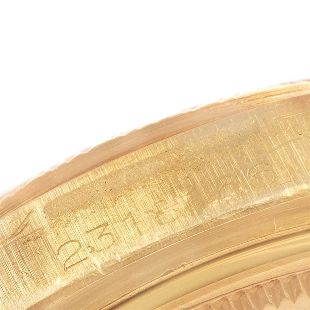 This image shows a close-up of the bezel and case of the Rolex President 1807 Men
s Yellow Gold White Dial 1807 Men
s Yellow Gold White Dial model watch.