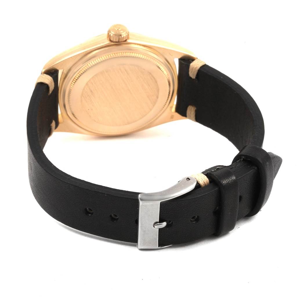 This image shows the back case and leather strap of a Rolex President 1803 Men
s Yellow Gold Silver Dial 1803 Men
s Yellow Gold Silver Dial model watch from a rear angle.
