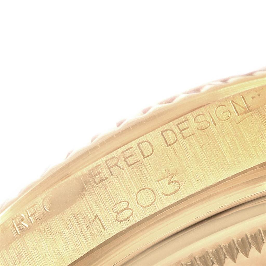 The image shows a close-up of a gold bezel and case side with engravings from the Rolex President 1803 Men
s Yellow Gold Silver Dial 1803 Men
s Yellow Gold Silver Dial model watch.