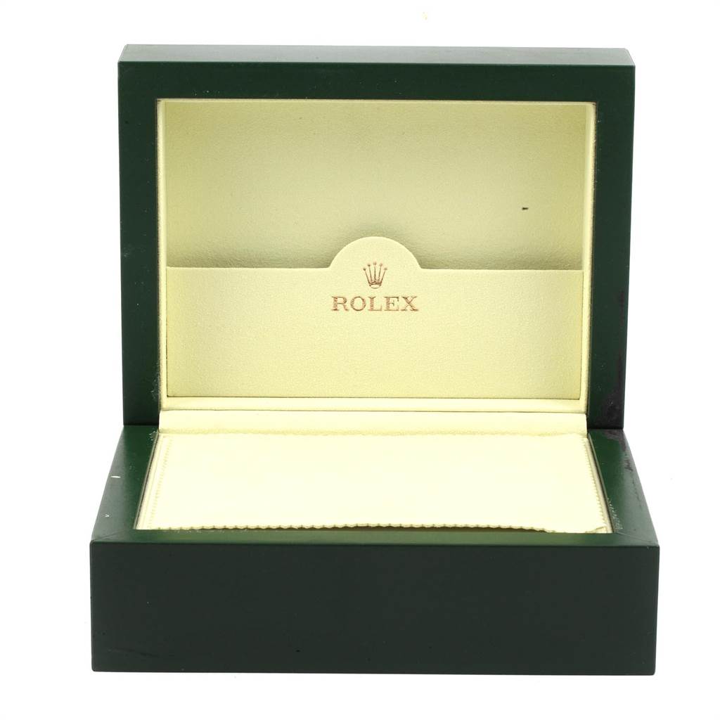 The image shows an open green and gold Rolex box, designed to hold the President model watch.