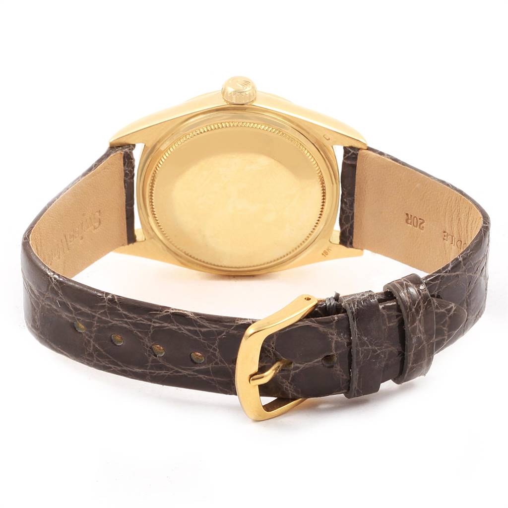 This image shows the back view of a Rolex President 1807 Men
s Yellow Gold Champagne Dial 1807 Men
s Yellow Gold Champagne Dial model watch, highlighting the case back and leather strap with a buckle.