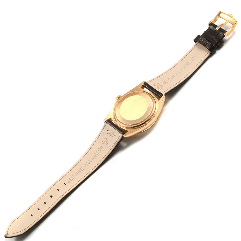 The image shows the back of a Rolex President 1803 Men
s Yellow Gold Champagne Dial 1803 Men
s Yellow Gold Champagne Dial model watch, highlighting the case back and leather strap.