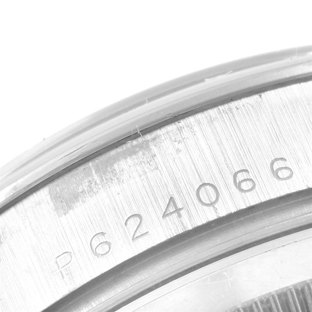 The image shows a close-up of the caseback edge of a Rolex President 118209 Men's White Gold Mother of Pearl Dial 118209 Men's White Gold Mother of Pearl Dial watch, featuring engraved serial numbers.