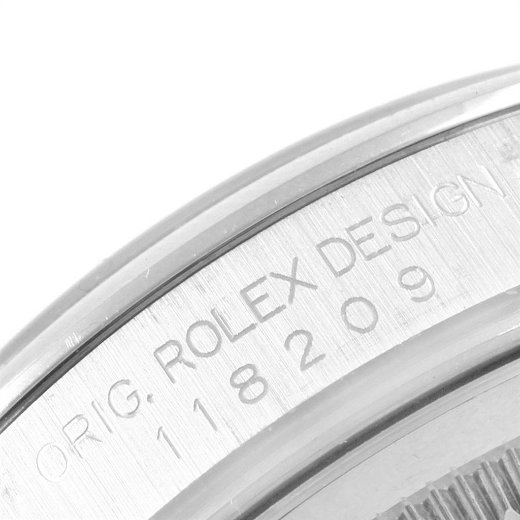 The image shows the engraved case back and serial number of the Rolex President 118209 Men's White Gold Mother of Pearl Dial 118209 Men's White Gold Mother of Pearl Dial model watch.