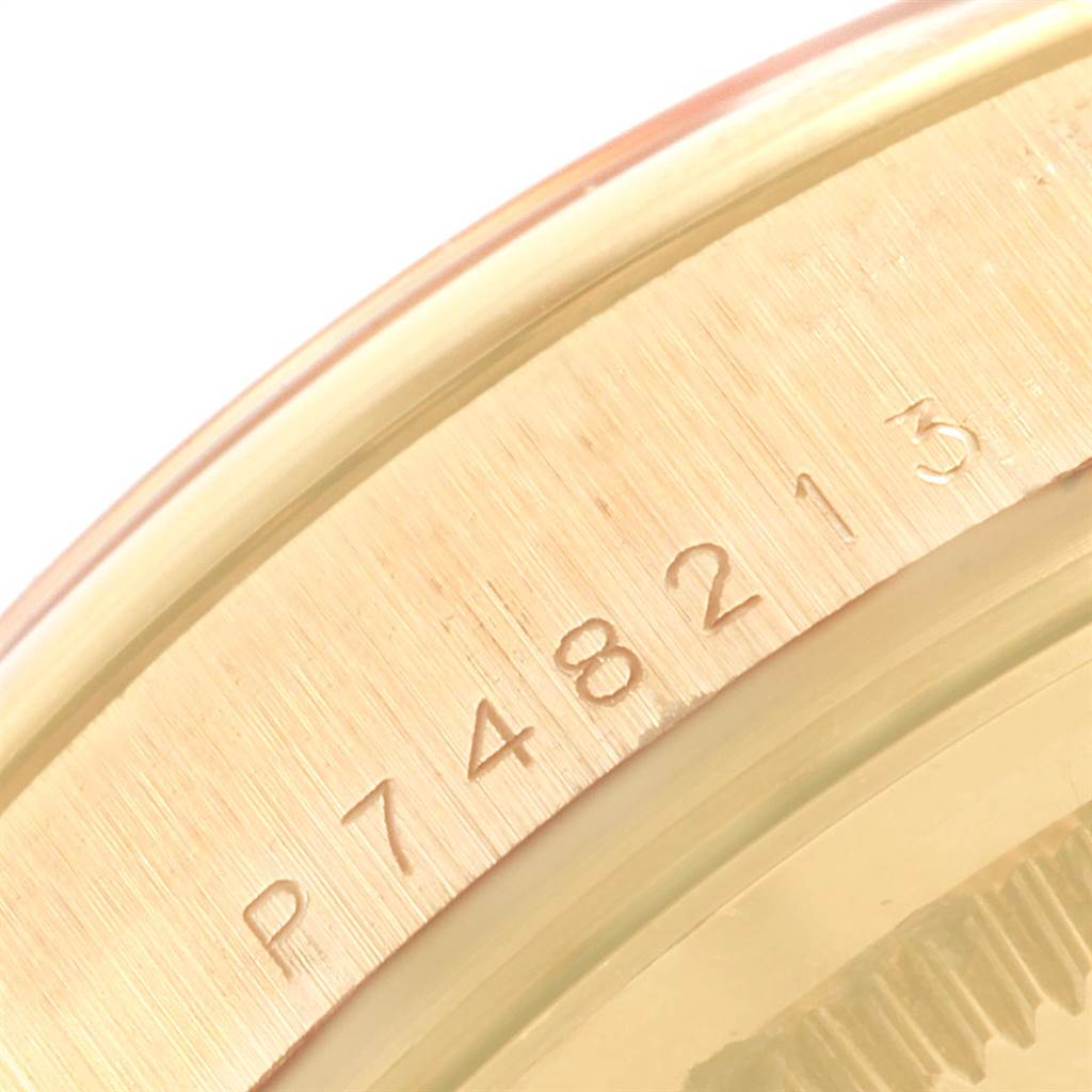 This close-up photo shows the serial number engraved on the edge of a Rolex President 118208 Men
s Yellow Gold Black Dial 118208 Men
s Yellow Gold Black Dial model watch.