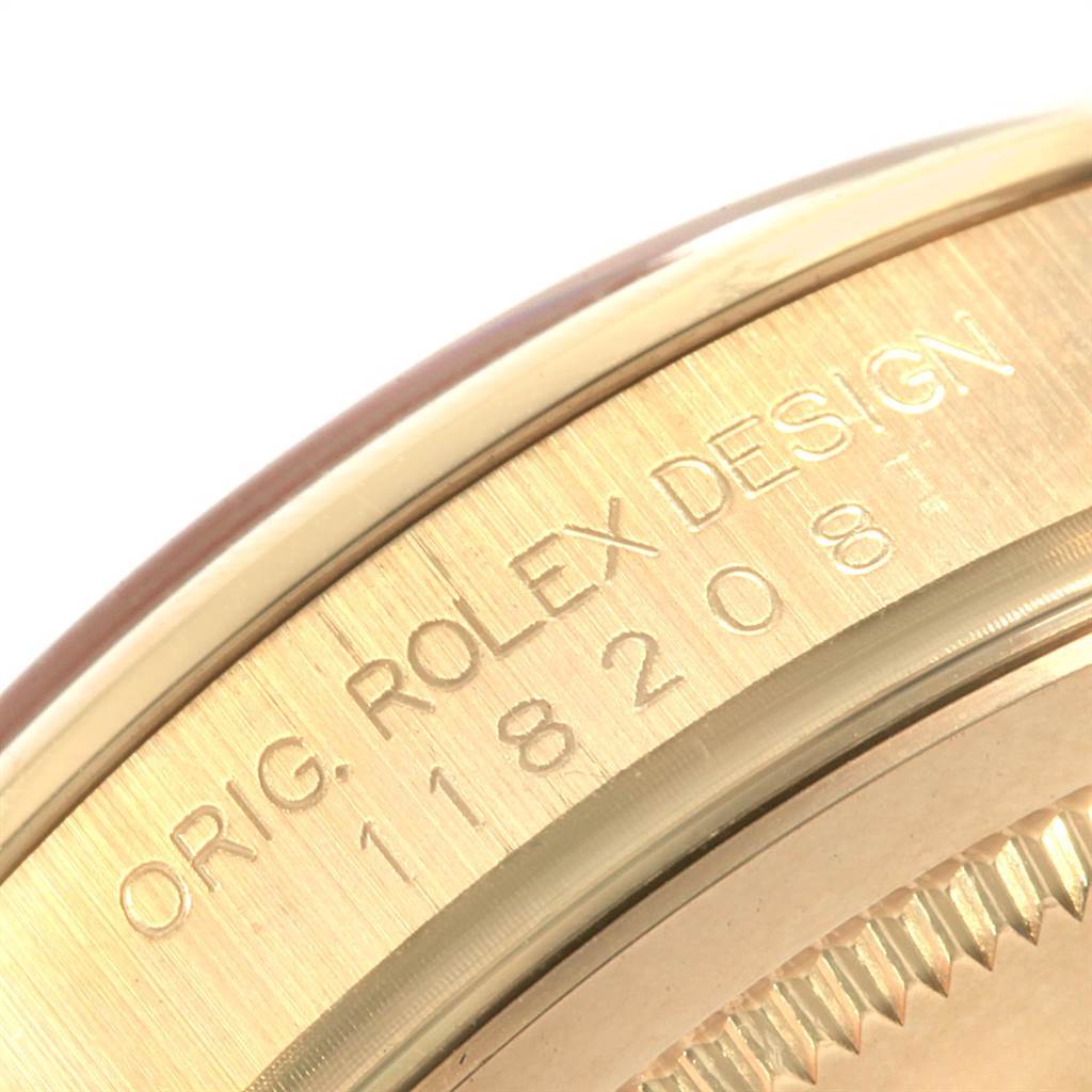 This image shows a close-up of the caseback edge of a Rolex President 118208 Men
s Yellow Gold Black Dial 118208 Men
s Yellow Gold Black Dial model watch, highlighting the engraved markings.