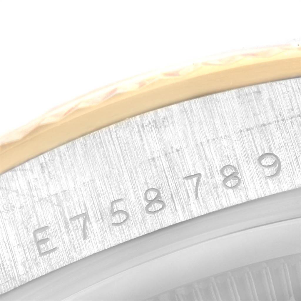 The image shows a close-up of the engraving details on the bezel of a Rolex President 18239 Men's White Gold Brown Dial 18239 Men's White Gold Brown Dial model watch.