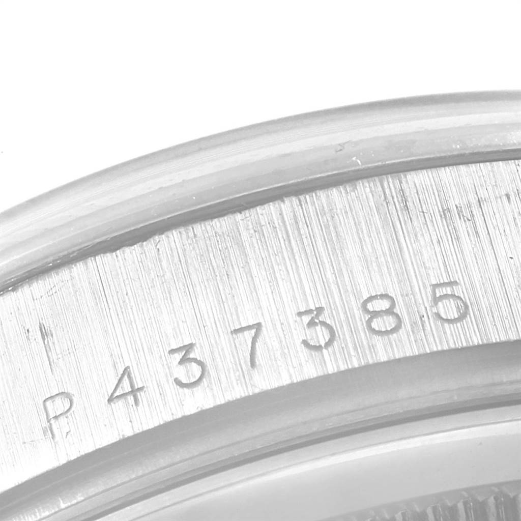 This image shows the serial number engraving on the caseback edge of a Rolex President 118209 Men's White Gold Black Dial 118209 Men's White Gold Black Dial model watch at a close-up angle.