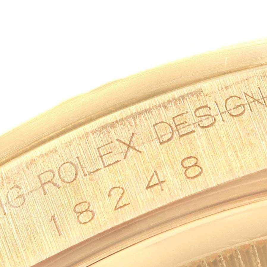The image shows a close-up of the serial number and 
Rolex Design
 engraving on the side of a Rolex President 18248 Men
s Yellow Gold Champagne Dial 18248 Men
s Yellow Gold Champagne Dial model watch.
