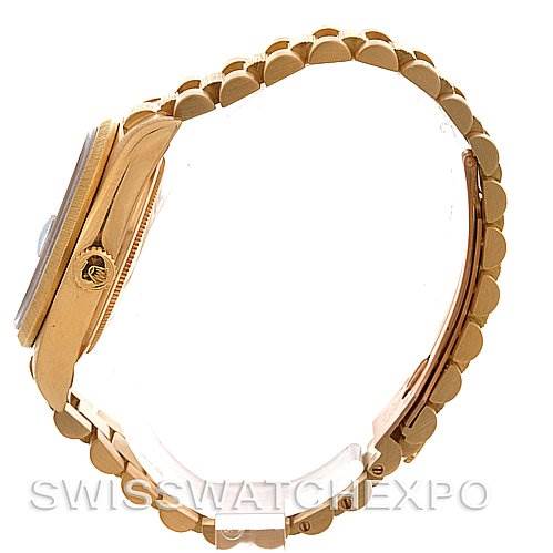 Side view of a Rolex President 18038 Men's Yellow Gold Blue Dial 18038 Men's Yellow Gold Blue Dial model watch showcasing its gold case, crown, and bracelet.