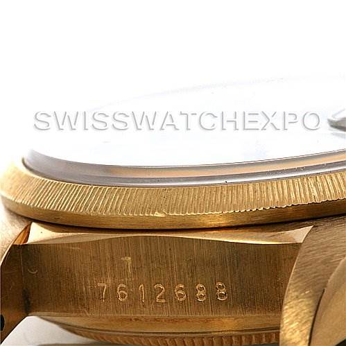 This image shows a close-up side angle of the bezel, crystal, and case serial number of a Rolex President 18038 Men's Yellow Gold Blue Dial 18038 Men's Yellow Gold Blue Dial model watch.