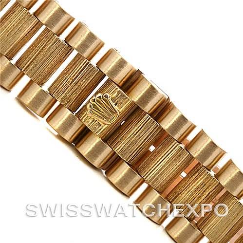 The image shows a close-up of the gold bracelet of a Rolex President 18038 Men's Yellow Gold Blue Dial 18038 Men's Yellow Gold Blue Dial model watch, highlighting the brand's crown logo.