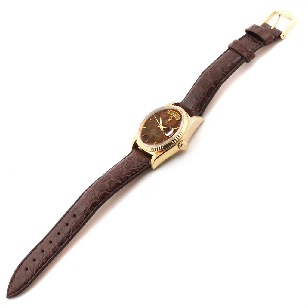 This Rolex President 18038 Men
s Yellow Gold Brown Dial 18038 Men
s Yellow Gold Brown Dial model watch is shown from an angled top view, displaying the face, case, and brown leather strap.