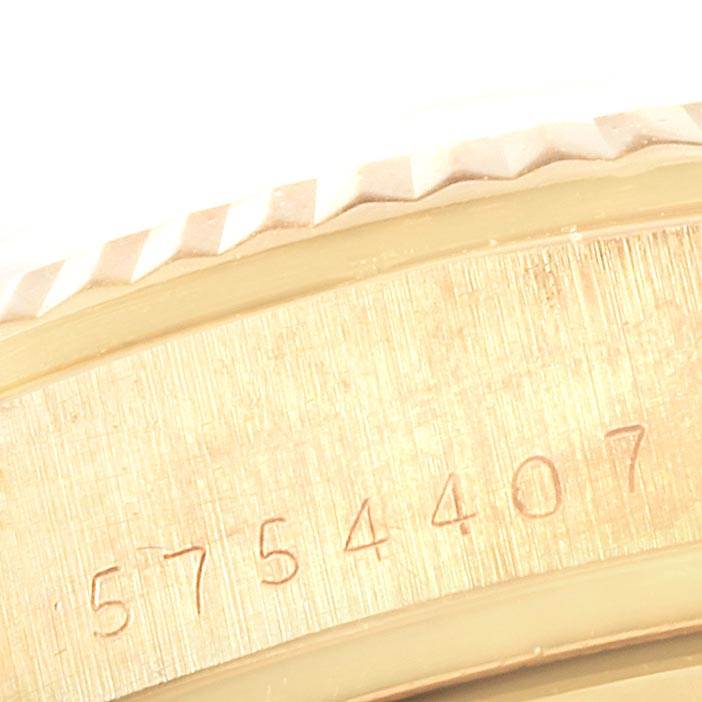 The image shows a close-up of the side of a Rolex President 18038 Men
s Yellow Gold Brown Dial 18038 Men
s Yellow Gold Brown Dial watch, focusing on the engraved serial number.