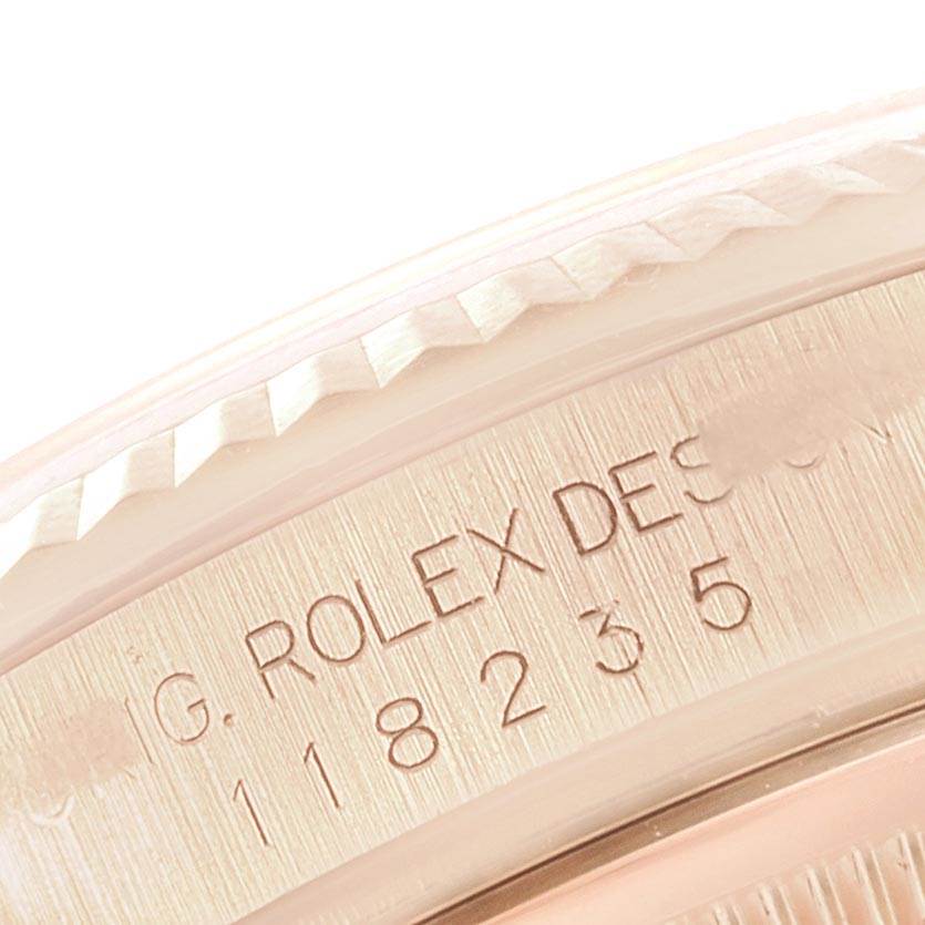 This close-up image shows the engraved serial number and part of the bezel of a Rolex President 118235 Men's Rose Gold White Dial 118235 Men's Rose Gold White Dial model watch.