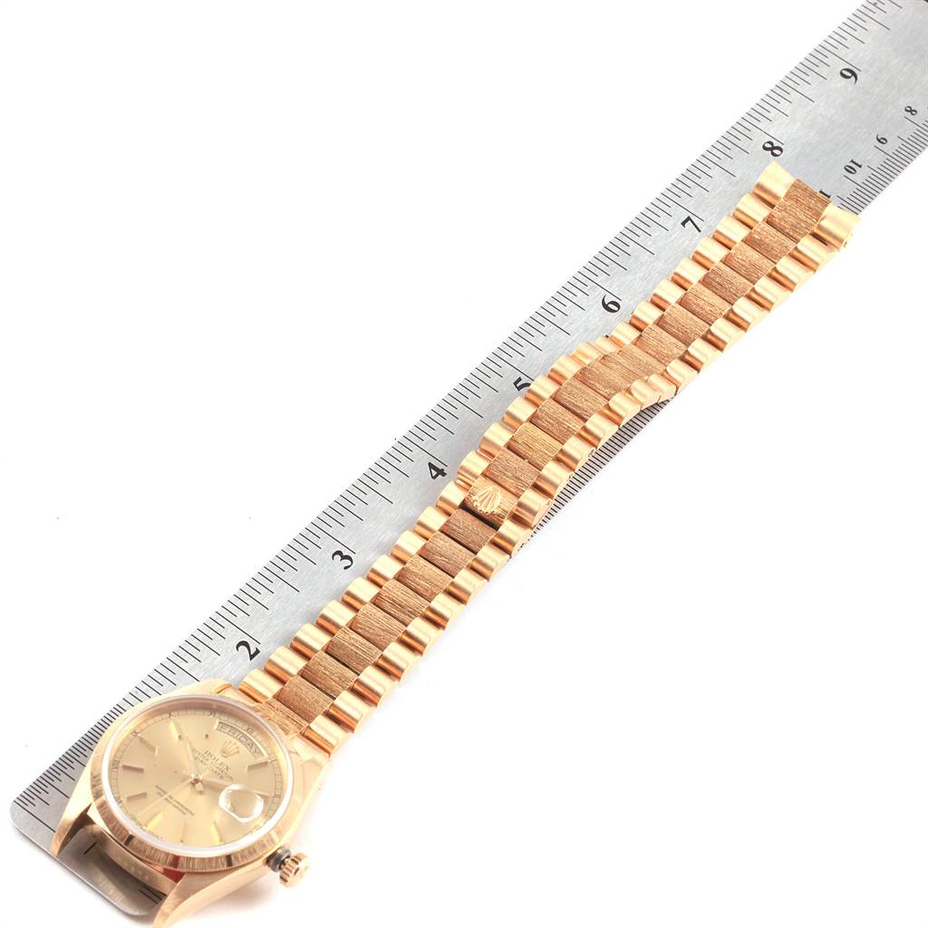 The image shows a Rolex President 18078 Men
s Yellow Gold Champagne Dial 18078 Men
s Yellow Gold Champagne Dial model watch laid flat, displaying the face, bezel, and bracelet alongside a ruler for scale.