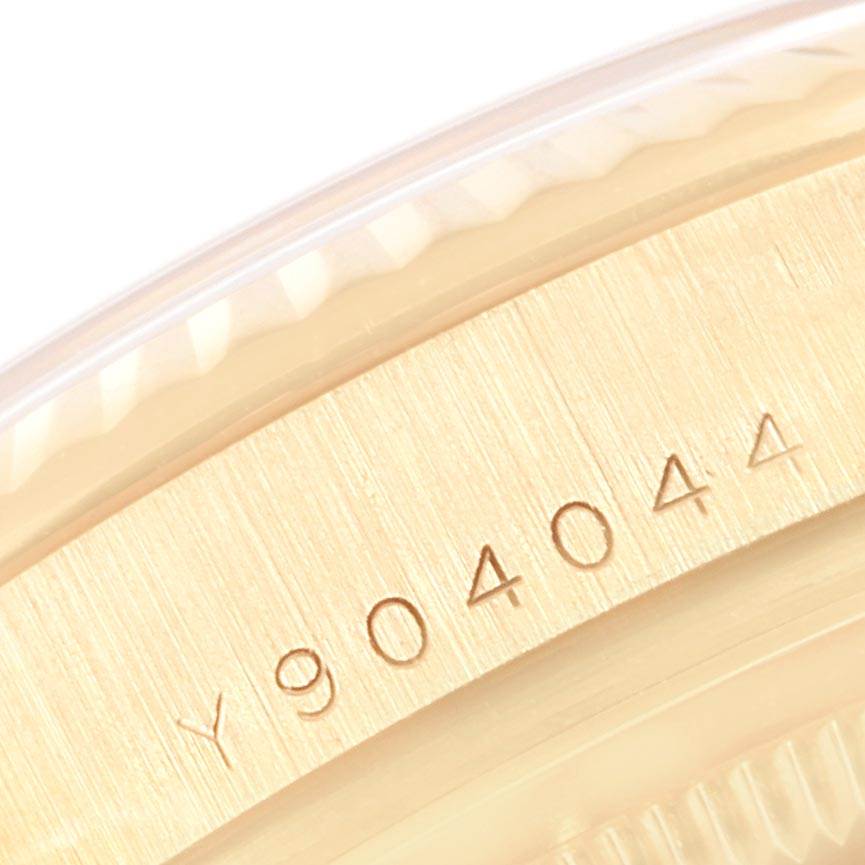This image shows a close-up of the serial number on the case of a Rolex President 118238 Men
s Yellow Gold White Dial 118238 Men
s Yellow Gold White Dial model watch.