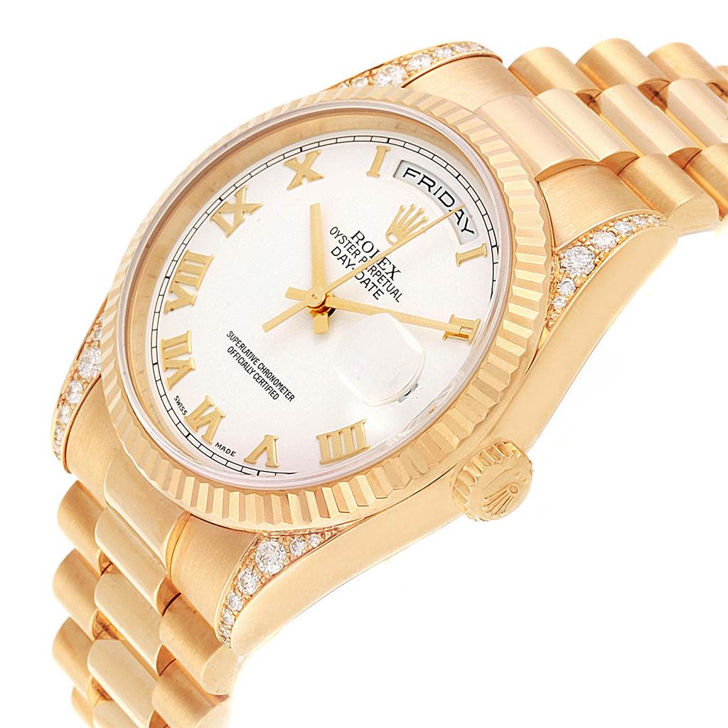 The image shows a close-up of a Rolex President 118338 Men
s Yellow Gold White Dial 118338 Men
s Yellow Gold White Dial watch, highlighting its face, band, and diamond accents from a tilted angle.