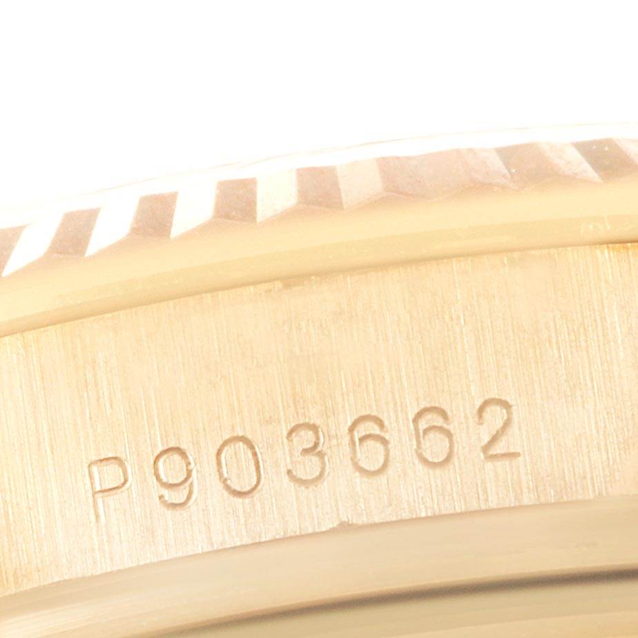 This image shows a close-up of the serial number and part of the bezel on a Rolex President 118338 Men
s Yellow Gold White Dial 118338 Men
s Yellow Gold White Dial model watch.