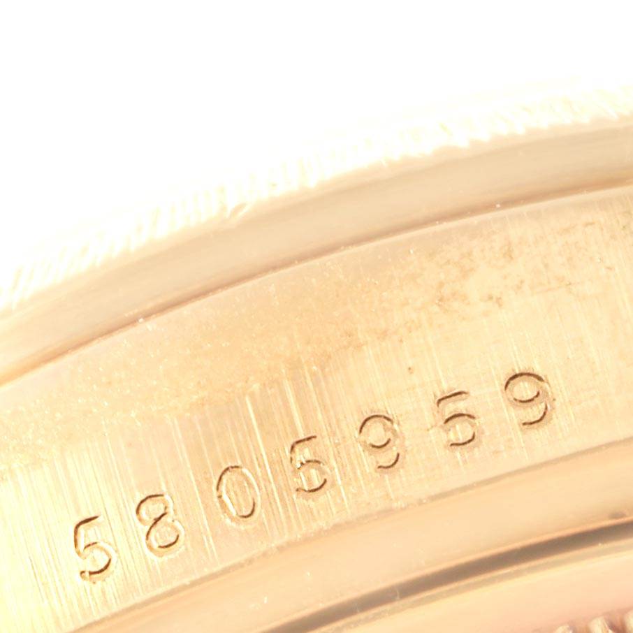 The image shows a close-up of the serial number engraving on the case of a Rolex President 18078 Men
s Yellow Gold Champagne Dial 18078 Men
s Yellow Gold Champagne Dial model watch.