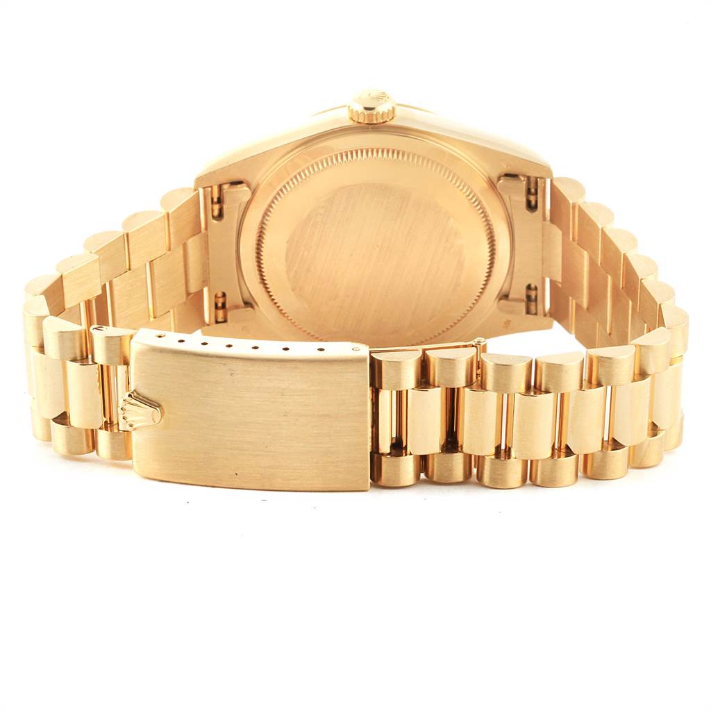 The image shows the back view of a Rolex President 18238 Men
s Yellow Gold Champagne Dial 18238 Men
s Yellow Gold Champagne Dial watch, highlighting its case back and bracelet clasp.