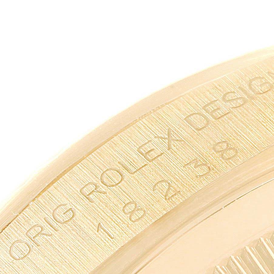 This image shows a close-up of the case side of the Rolex President 18238 Men's Yellow Gold Champagne Dial 18238 Men's Yellow Gold Champagne Dial model, displaying part of the serial number and engraving.