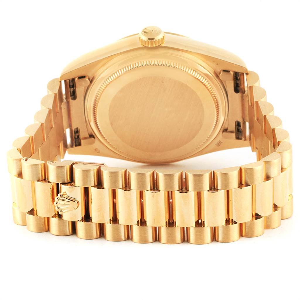 The image shows the back view of a Rolex President 18038 Men's Yellow Gold Champagne Dial 18038 Men's Yellow Gold Champagne Dial model watch featuring its case back and gold President bracelet.