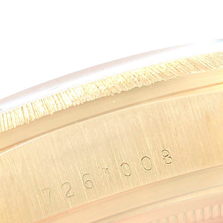 The image shows a close-up of the side view of a Rolex President 18078 Men's Yellow Gold Champagne Dial 18078 Men's Yellow Gold Champagne Dial model watch case, displaying part of the serial number.