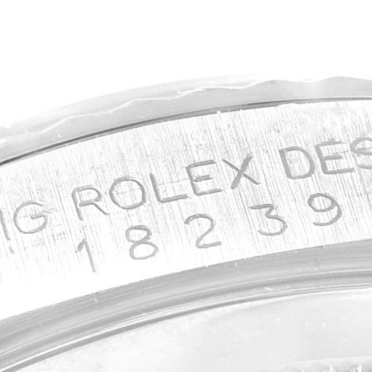The close-up image shows the engraved serial number and part of the bezel of a Rolex President 18239 Men's White Gold Silver Dial 18239 Men's White Gold Silver Dial model watch.
