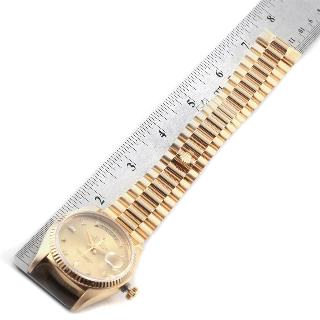 The angle shows the Rolex President 18038 Men's Yellow Gold Champagne Dial 18038 Men's Yellow Gold Champagne Dial watch laid flat beside a ruler, displaying the dial, case, and bracelet.