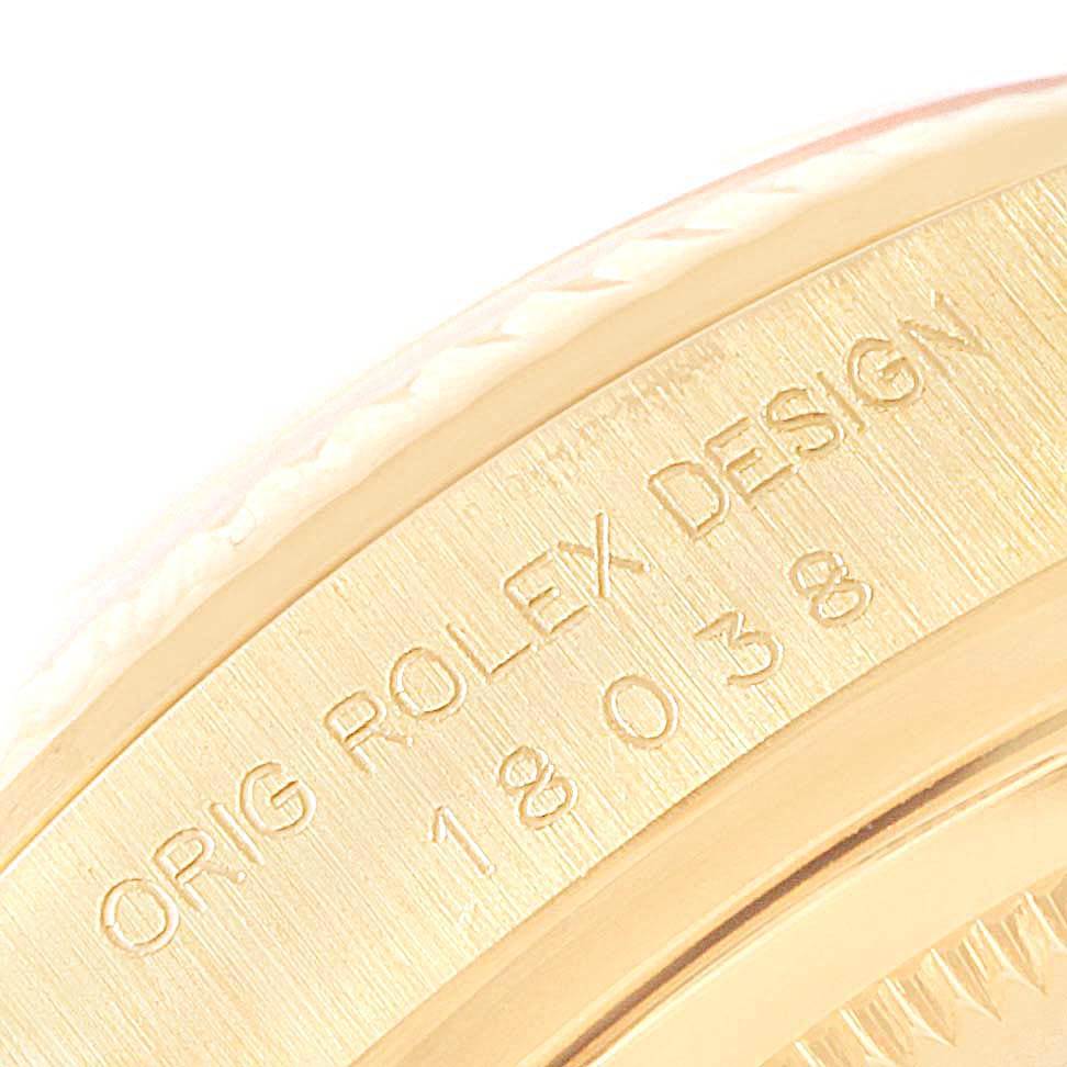 This image shows a close-up of the engravings on the side of a Rolex President 18038 Men's Yellow Gold Blue Dial 18038 Men's Yellow Gold Blue Dial model watch, highlighting the text "ORIG ROLEX DESIGN" and model number.