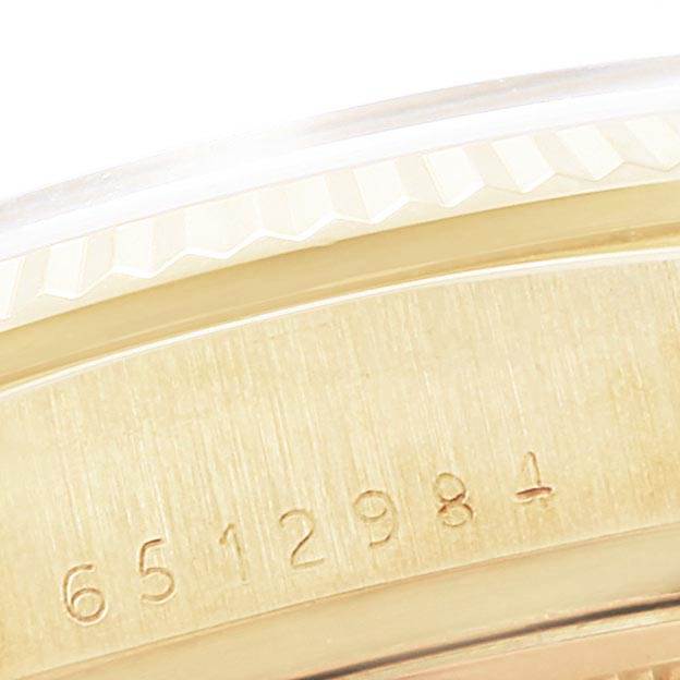 This close-up shows the serial number engraved on the golden case of the Rolex President 18038 Men's Yellow Gold Blue Dial 18038 Men's Yellow Gold Blue Dial model watch.