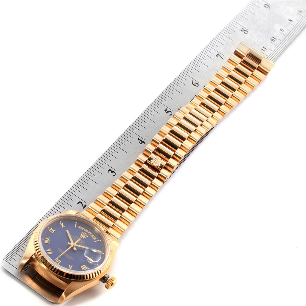 The image shows a Rolex President 18038 Men's Yellow Gold Blue Dial 18038 Men's Yellow Gold Blue Dial watch laid flat on a ruler, displaying the face and bracelet.