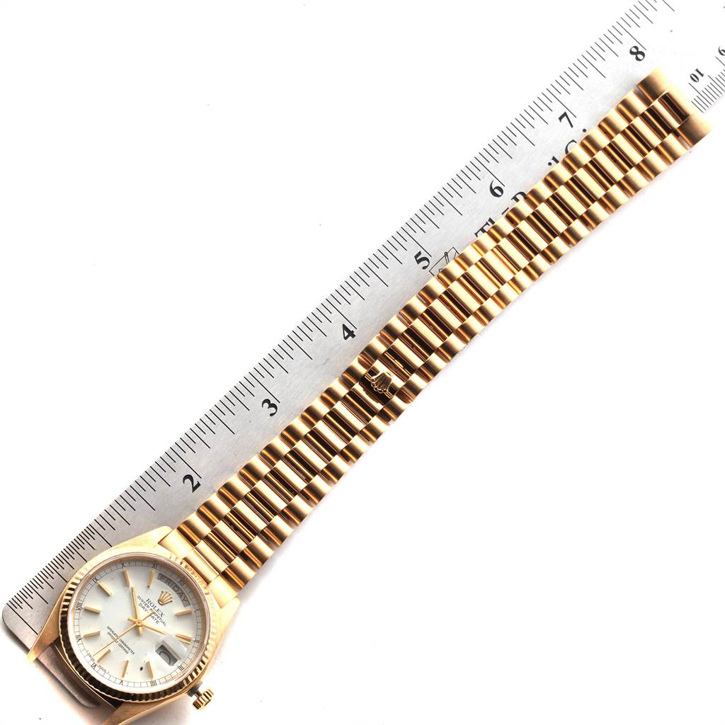 The Rolex President 18038 Men
s Stainless Steel White Dial 18038 Men
s Stainless Steel White Dial model watch is shown flat with the face, bracelet, and clasp visible against a ruler for scale.
