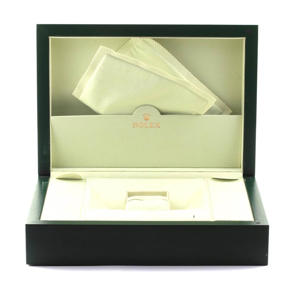 This image shows an open green and cream Rolex box for a President model watch with a cloth inside.