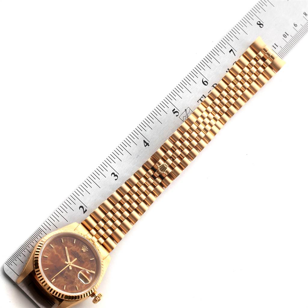 The image shows a gold Rolex President 16238 Men
s Yellow Gold Brown Dial 16238 Men
s Yellow Gold Brown Dial model watch with its bracelet laid out flat beside a ruler, highlighting its length.