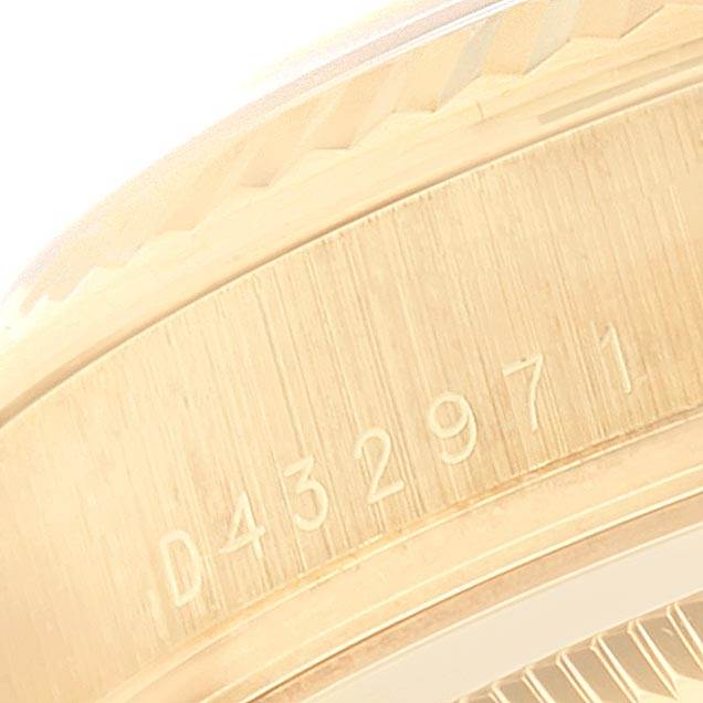 This image shows a close-up of the side of a Rolex President 118238 Men
s Yellow Gold Silver Dial 118238 Men
s Yellow Gold Silver Dial model watch, focusing on its engraved serial number.