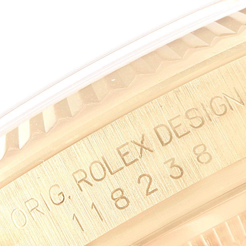 The image shows a close-up of the case side engraving of a Rolex President 118238 Men
s Yellow Gold Silver Dial 118238 Men
s Yellow Gold Silver Dial model watch, highlighting "ORIG. ROLEX DESIGN" and the model number.