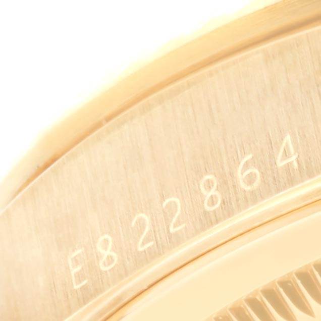 This image shows a close-up of the serial number on the back of a Rolex President 18238 Men
s Yellow Gold Black Dial 18238 Men
s Yellow Gold Black Dial model watch.